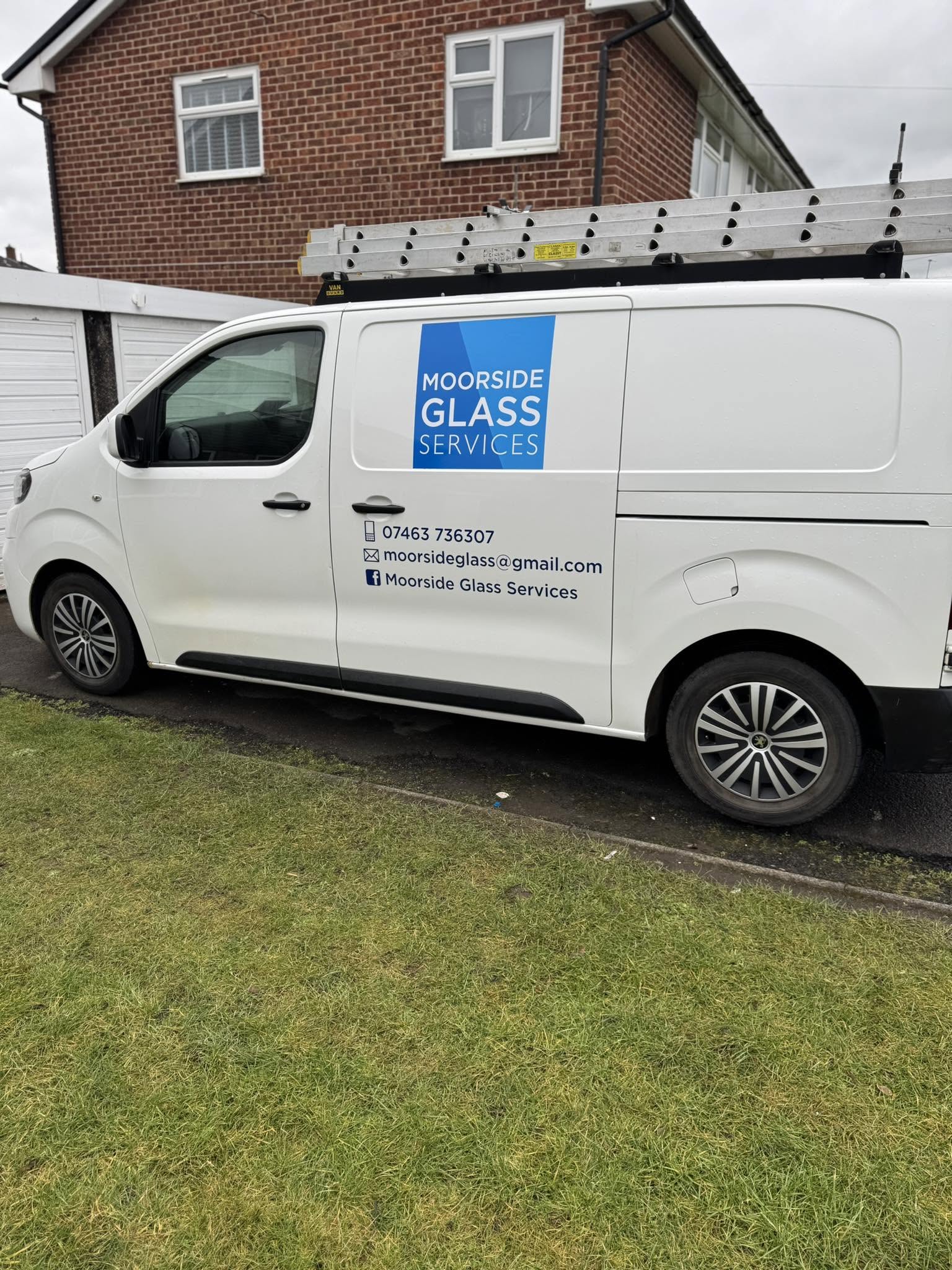 The white Moorside Glass Services van with the blue logo on the side